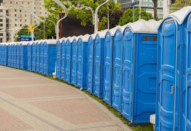 portable restrooms stationed outside of a high-profile event, with attendants available for assistance in Sandy